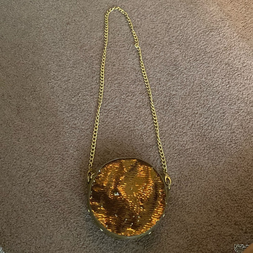Sequin copper color circle purse with gold chain strap.